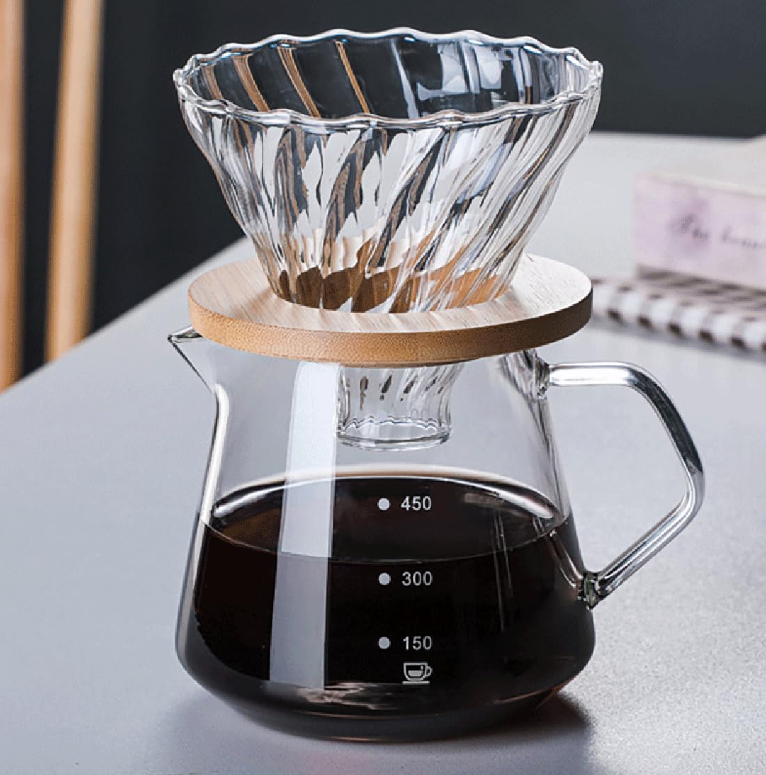 Glass pour-over dripper on bamboo stand